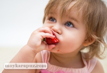 Ребенок ест сочную клубнику